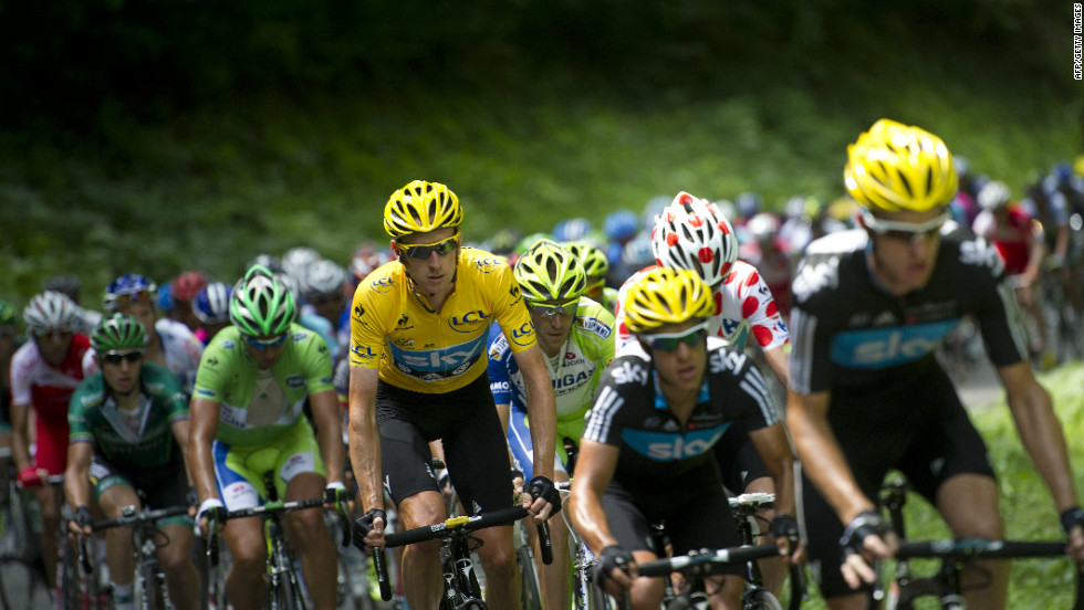 Overall leader Bradley Wiggins of Great Britain rides in the peloton with his Team Sky teammates Sunday.