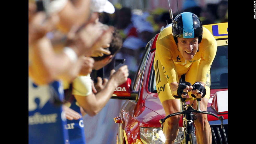 Team Sky rider Bradley Wiggins of Britain, in the leader&#39;s yellow jersey, crosses the finish line during the individual time trial in the ninth stage of the 99th Tour de France cycling race between Arc et Senans and Besancon on Monday, July 9. 