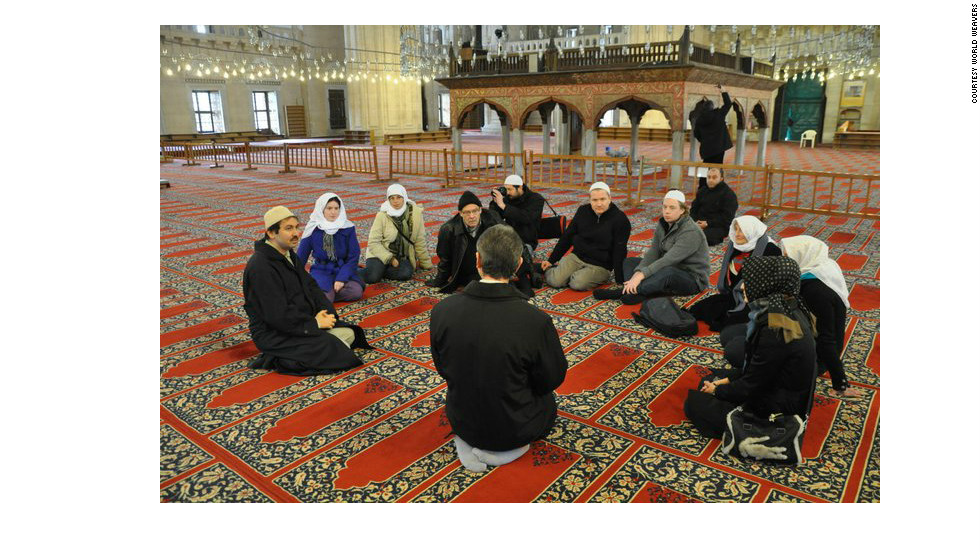 The tour group inside Istanbul&#39;s Blue Mosque, being taught Islamic practices.