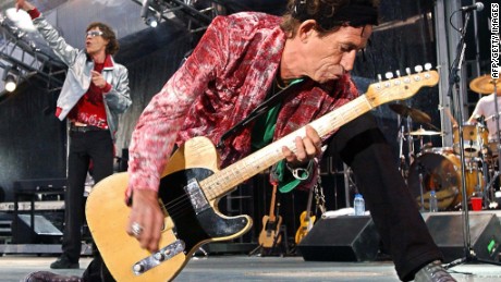 Rolling Stones guitarist Keith Richards (R) rocks the house, as singer Mick Jagger (L) belts out a favorite during their concert in Munich, June 6, 2003.