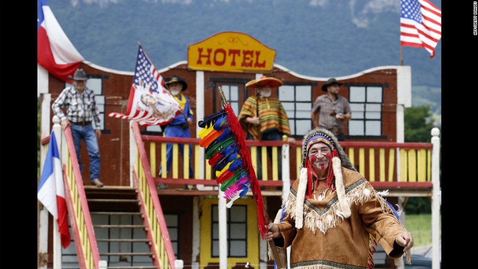 Fans wait for riders in Western garb during stage 12 Friday.