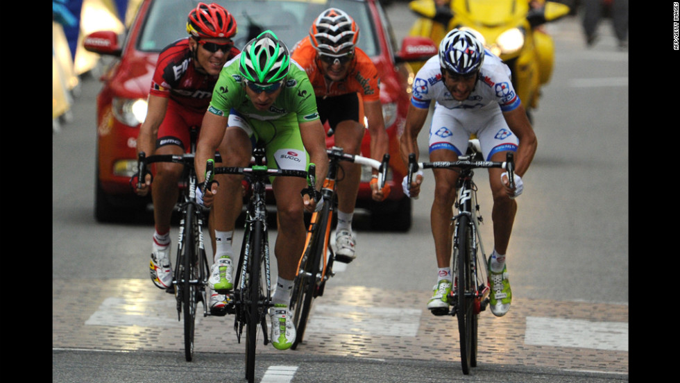 Slovakia&#39;s Peter Sagan, wearing the green jersey of the sprint points leader, reaches for second place at the finish of the race Sunday and maintains his lead as sprints points leader, 97 points ahead of Andre Greipel of Germany.