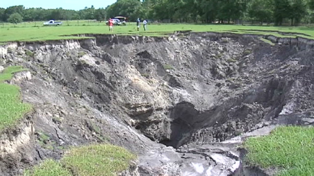 Giant sinkhole swallows pasture - CNN Video