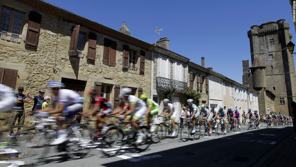 Spectators cheer on riders as they pass through a small village along Monday&#39;s route.