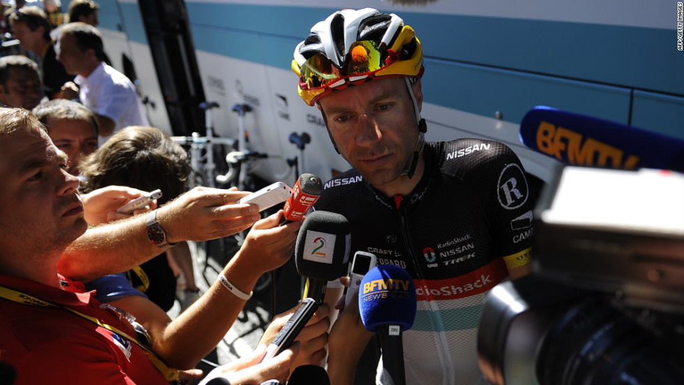 Germany&#39;s Jens Voigt of team Radioshack-Nissan answers journalists&#39; questions Wednesday after teammate Frank Schleck tested positive for a banned substance overnight and withdrew from the race.