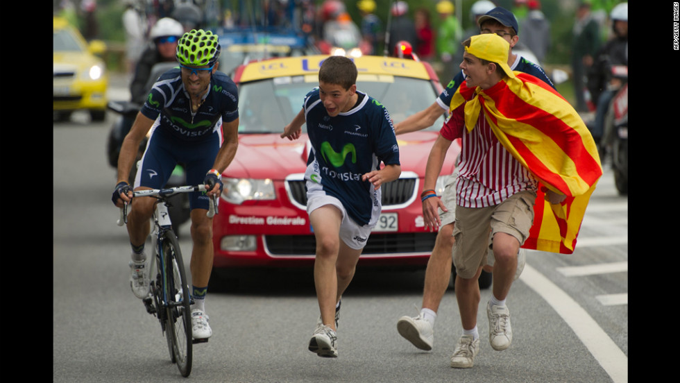 Spectators cheer on Spain&#39;s Alejandro Valverde as he rides to victory during the 143.5 kilometer (89 miles) Stage 17, starting in Bagneres-de-Luchon and finishing in the ski resort of Peyragudes, southern France, on Thursday, July 19. 