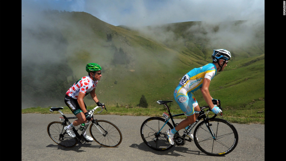 Thomas Voeckler of France and Fredrik Kessiakoff of Sweden ride in a breakaway group together through the Pyrenees mountains.