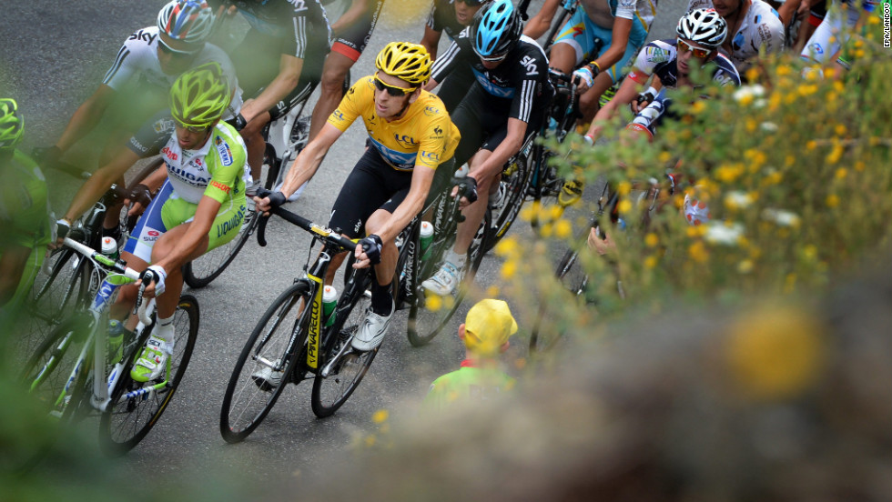 Overall race leader Bradley Wiggins of Great Britain, in yellow, rides in the main group during Thursday&#39;s race.