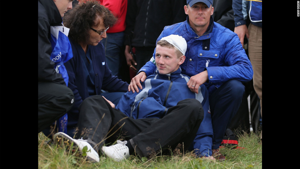 Jason Blue of Bristol gets medical attention after he was struck by Rory McIlroy&#39;s golf ball on the 15th hole on Thursday.