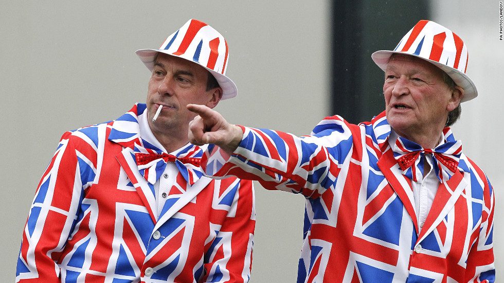 Golf fans don matching Union Jack suits for early action Thursday, the first day of the British Open.