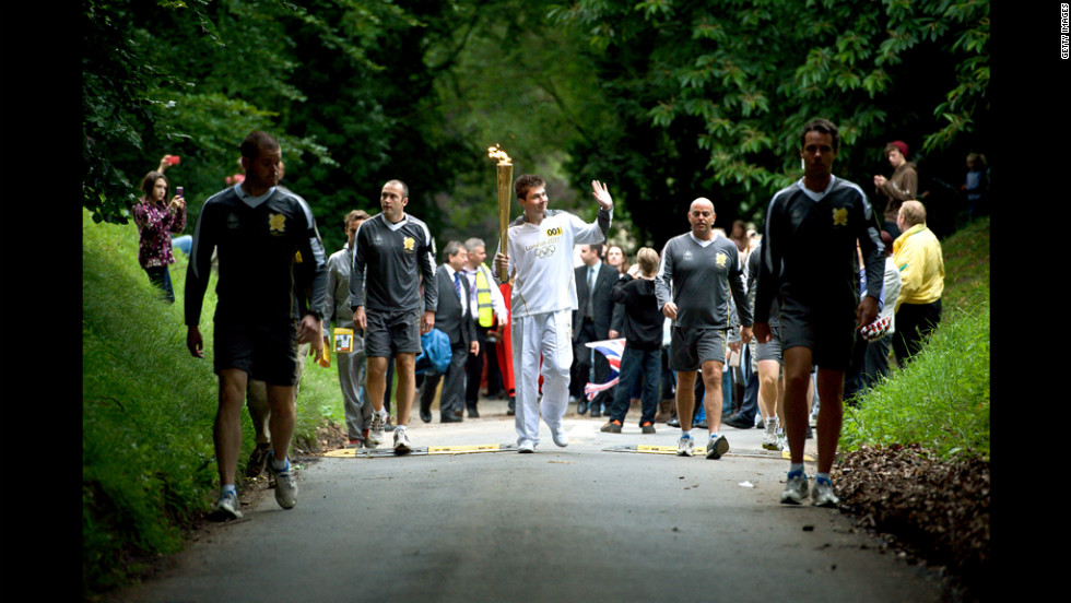 Christopher Bury carries the flame through Mote Park in Maidstone, England, on July 20.
