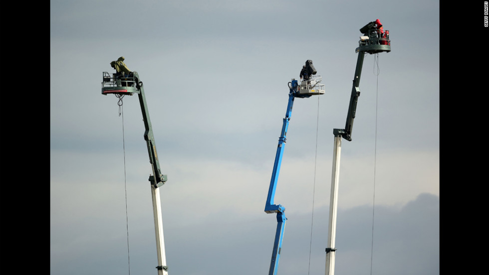 TV towers loom over the course during the second round Friday.