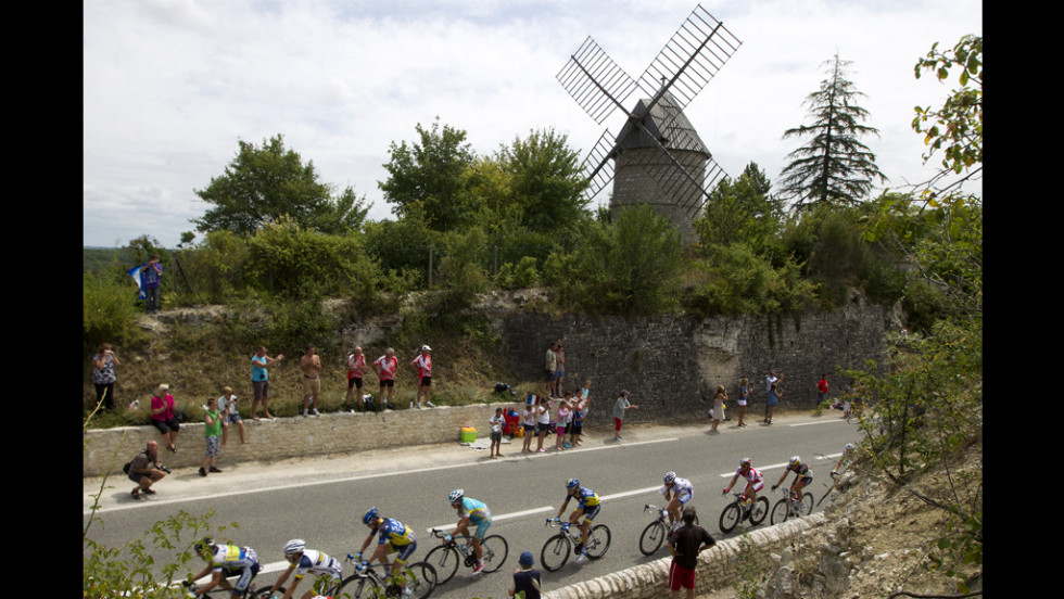 Fans cheer on the pack riding past a windmill on Friday.