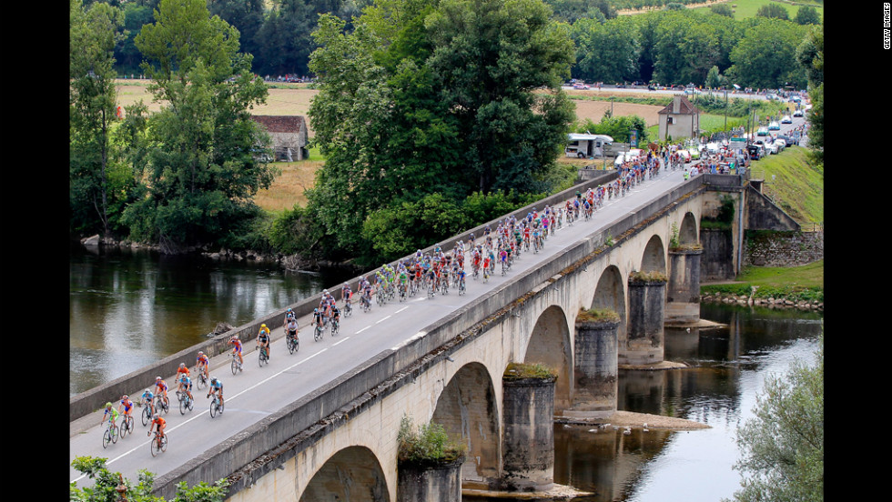 The peloton crosses La Dordogne River during Stage 18 on Friday.