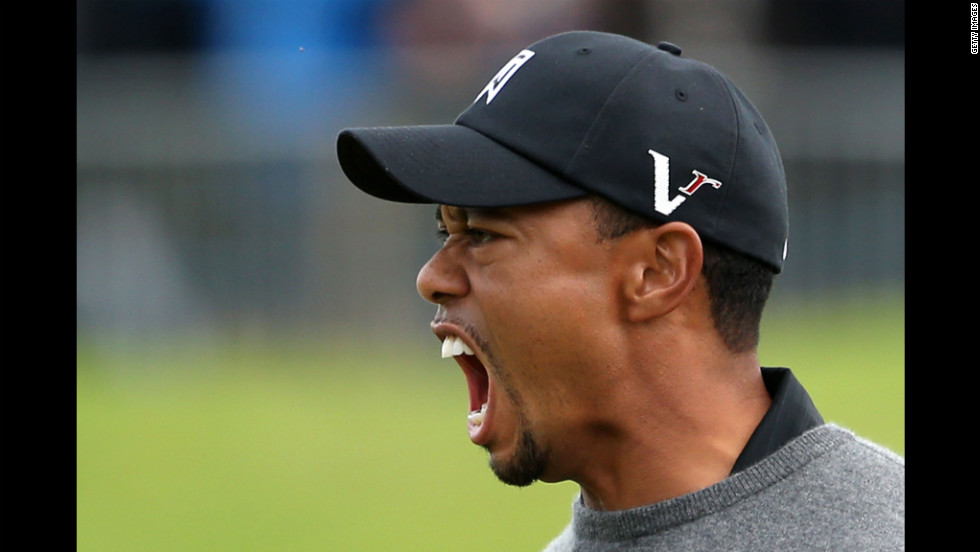 Woods celebrates after holing out from a bunker for birdie on the 18th hole, finishing Friday&#39;s second round with a three-under-par 67.