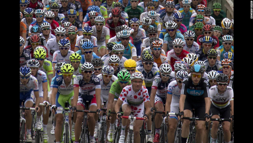 France&#39;s Thomas Voeckler (in the best climber&#39;s polka dot jersey), Slovakia&#39;s Peter Sagan (in the best sprinter&#39;s green jersey) and stage winner Great Britain&#39;s Mark Cavendish ride in the pack in the 222.5 km 18th stage of the 2012 Tour de France on Friday, July 20.