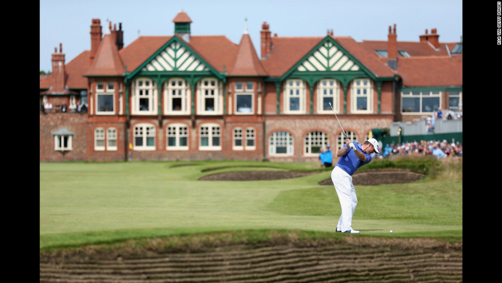 Lee Westwood of England hits his approach to the 18th green.