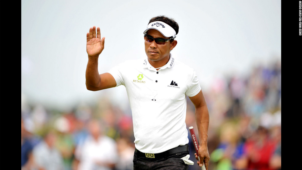 Golfer Thongchai Jaidee of Thailand waves to the gallery after making a putt on Saturday.