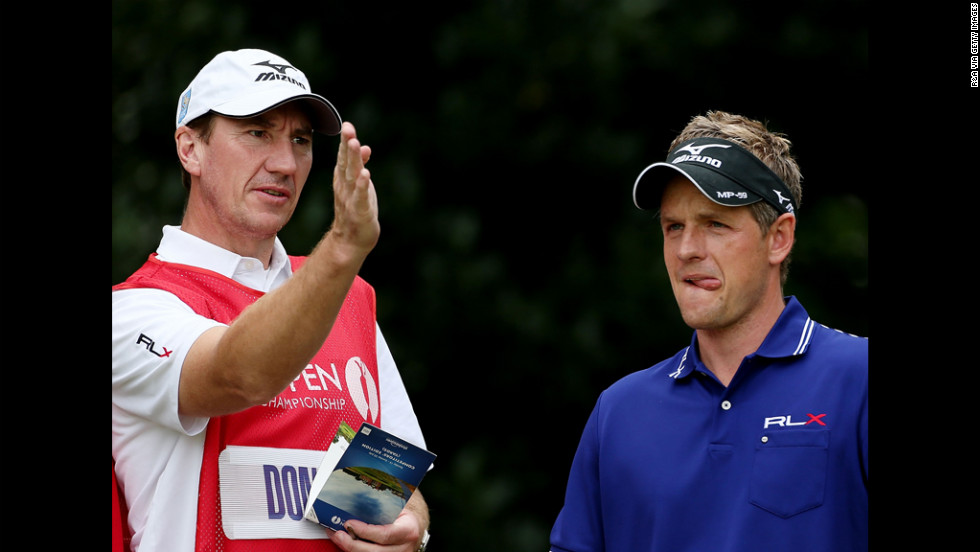 Luke Donald of England talks with caddie John McLaren.