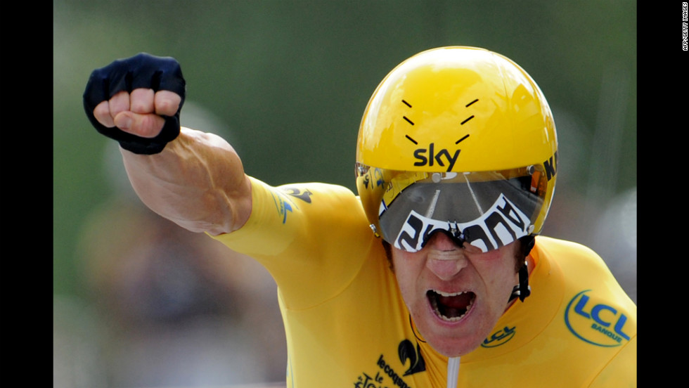 Briton Bradley Wiggins, wearing the leader&#39;s yellow jersey, celebrates finishing the 19th stage of the 2012 Tour de France on Saturday, July 21.