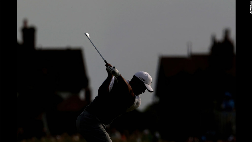Tiger Woods hits his second shot on the 17th hole on Saturday. Woods finished the third round alone in fourth place, five shots behind Adam Scott.