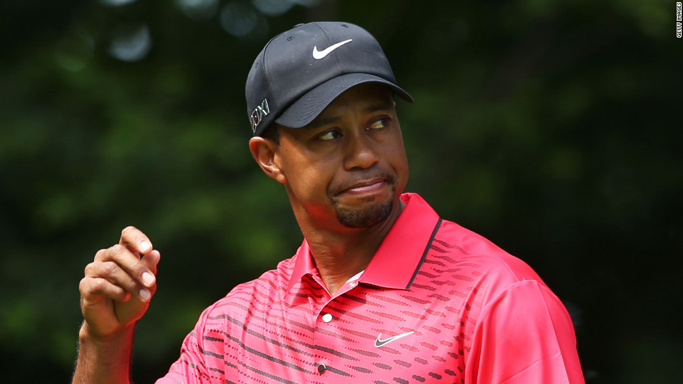 Woods acknowledges the crowd as he prepares to begin his final round of play Sunday.