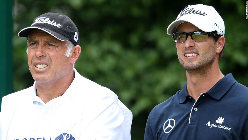 Scott and caddie Steve Williams watch the action on the first hole Sunday.