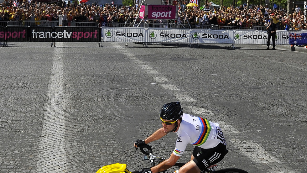 Cavendish and Wiggins, in yellow, ride past the Arc de Triomphe as the three-week race comes to an end in Paris on Sunday.