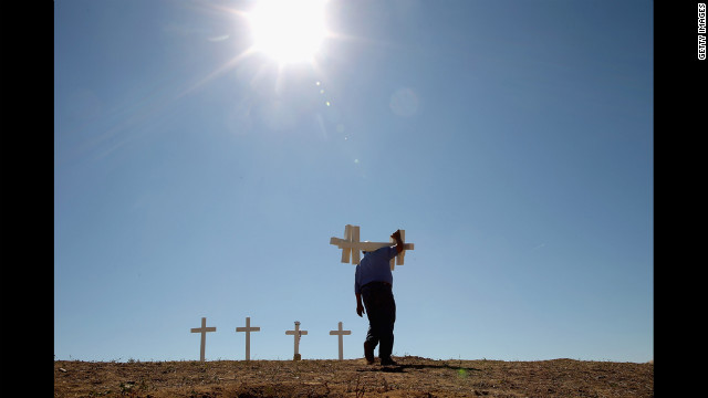 Zanis carries crosses for victims of the 2012 mass shooting at a theater in Aurora, Colorado.