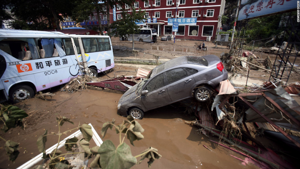 Weekend flooding leaves vehicles tossed about on roads in Laishui, a town in northern China&#39;s Hebei province.