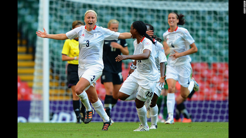 Britain&#39;s Stephanie Houghton celebrates a goal, adding the first point to the scoreboard, with teammate Ifeoma Diek.