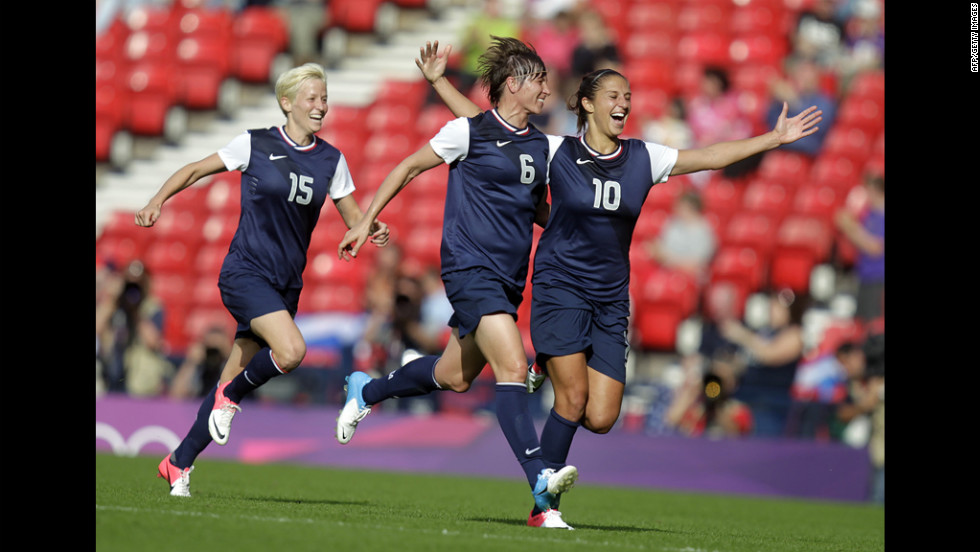 American Carli Lloyd celebrates with teammate Amy Le Peilbet after scoring her team&#39;s third goal.