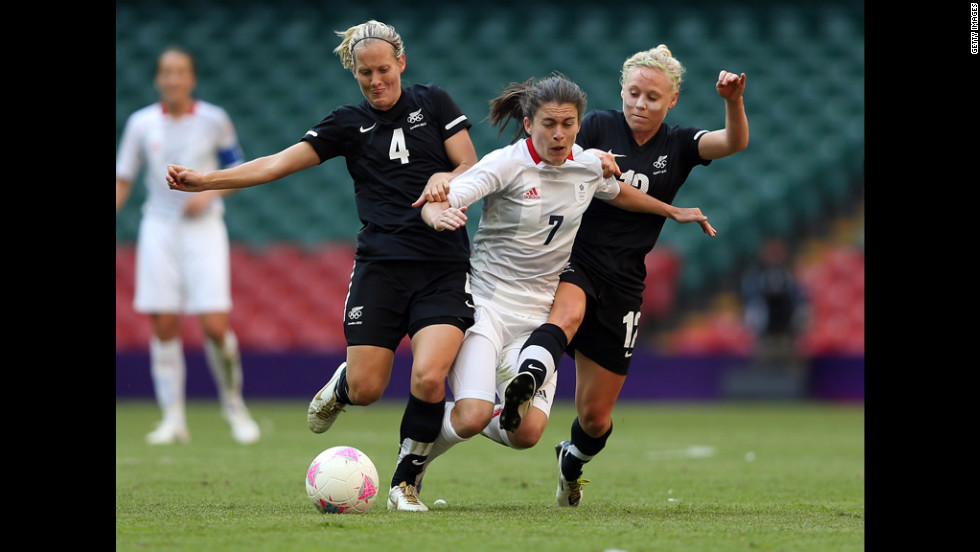 Katie Hoyle, left, of New Zealand and teammate Betsy Hassett challenge Karen Carney of Great Britain during their match in the first round of women&#39;s soccer in the London 2012 Olympic Games at Millennium Stadium on Wednesday, July 25, in Cardiff, Wales.