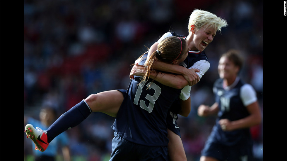 U.S. player Megan Rapinoe jumps on teammate Alex Morgan, No. 13, after Morgan scored during their Group G Olympic women&#39;s soccer match against France at Hampden Park in Glasgow, Scotland, on Wednesday, July 25. 