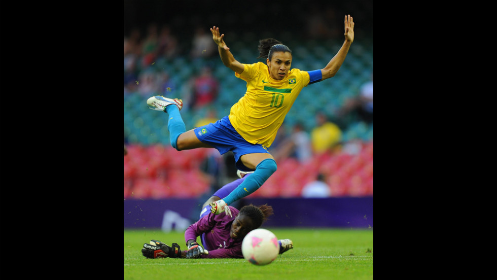Brazil&#39;s Marta is in action with Cameroon&#39;s goalkeeper Annette Ngo Ndom during the first-round women&#39;s football competition at Millennium Stadium on Wednesday.