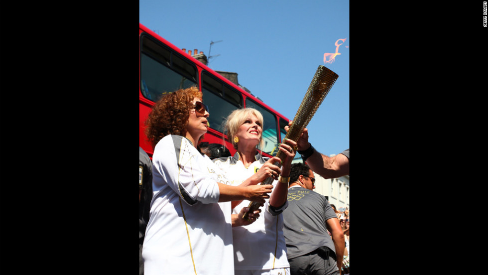 Torchbearers Jennifer Saunders and Joanna Lumley, known for their &quot;Absolutely Fabulous&quot; characters Edina and Patsy, carry the Olympic flame through Lambeth, Kensington and Chelsea on Thursday,  July 26, in London.
