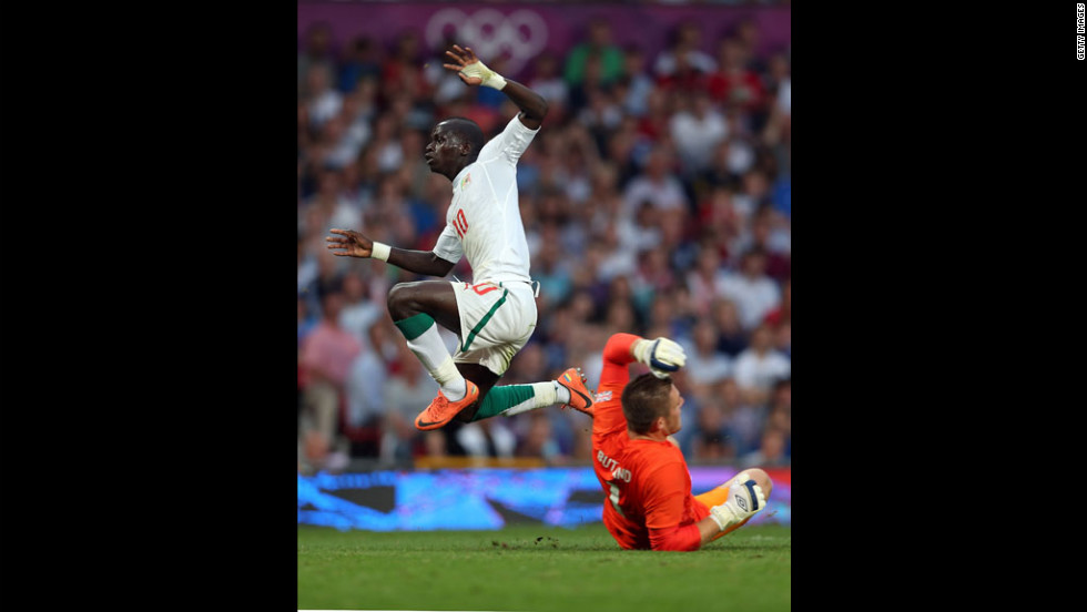 Sadio Mane of Senegal leaps over goalkeeper Jack Butland of Great Britain during the first-round men&#39;s soccer match between Great Britain and Senegal at Old Trafford on Thursday, July 26,  in Manchester, England.