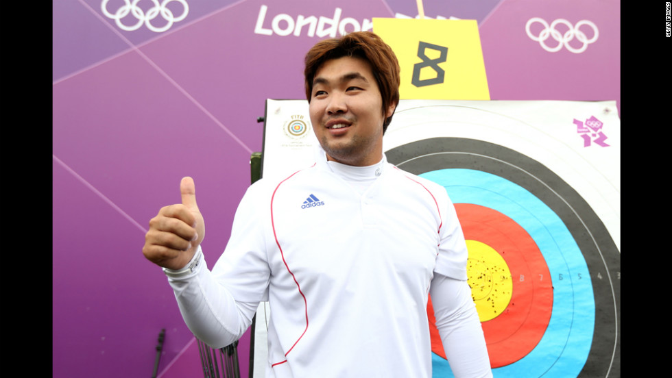 South Korean archer Im Dong Hyun celebrates breaking the first world record of the London Olympics on Friday. The two-time gold medalist, who is classified as legally blind and can&#39;t see out of his right eye, bettered his own 72-arrow mark in the qualification competition.