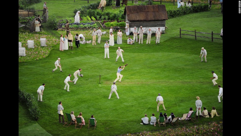 Cricketers play on the pitch during the preshow.