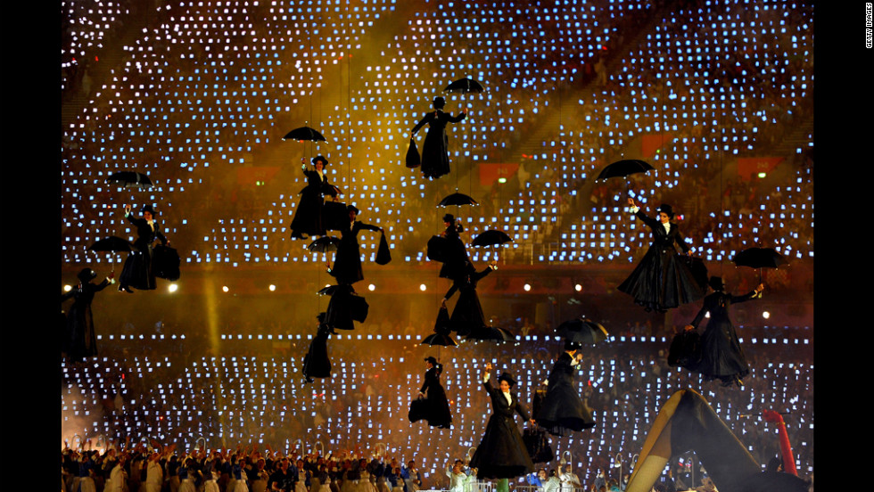 Performers float with umbrellas as they play the role of Mary Poppins.