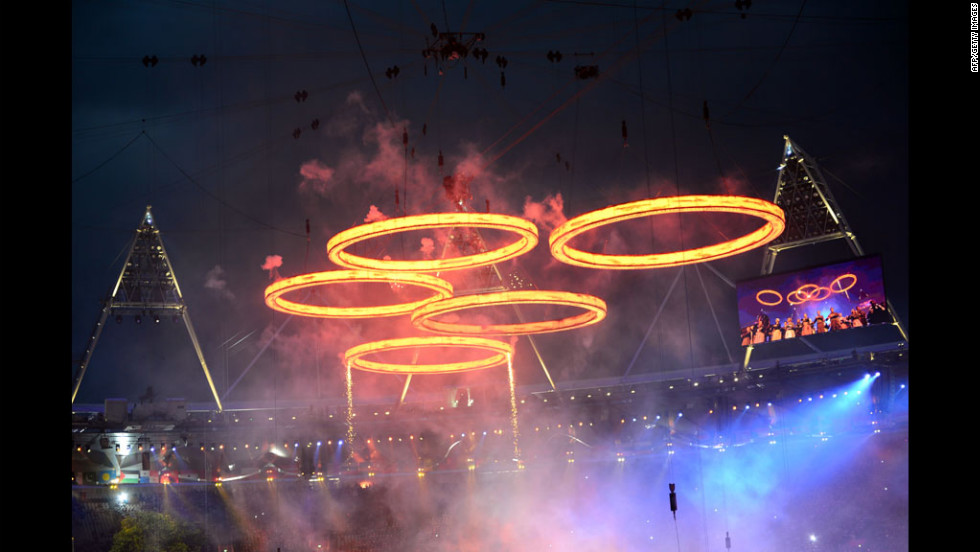 Freshly &quot;forged&quot; Olympic Rings fly above the chimneys during The Age of Industry scene.