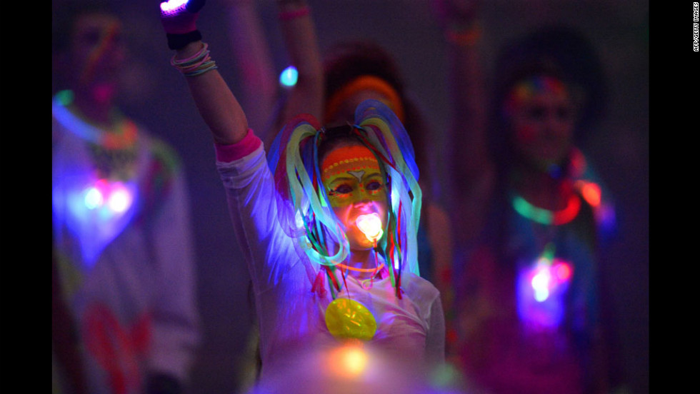 An artist performs with a glowing pacifier during the opening ceremony.