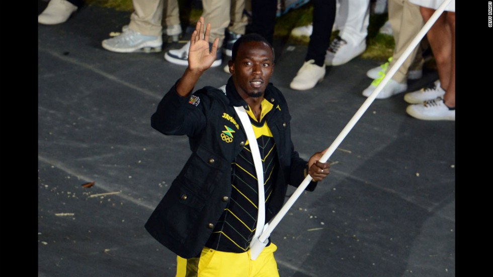 Reigning Olympic men&#39;s 100-meter and 200-meter champion Usain Bolt of Jamaica carries his country&#39;s flag.