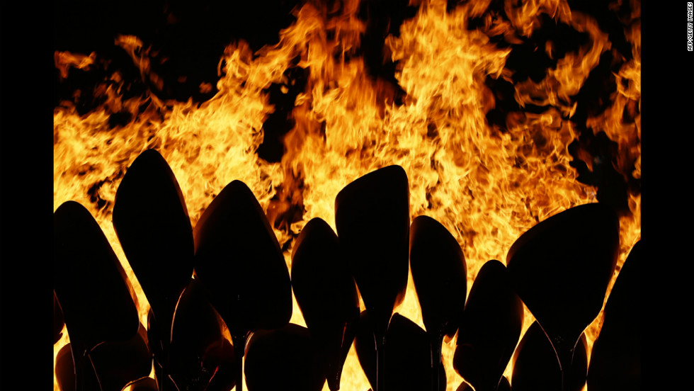 The Olympic flame is seen in the stadium during the ceremony.