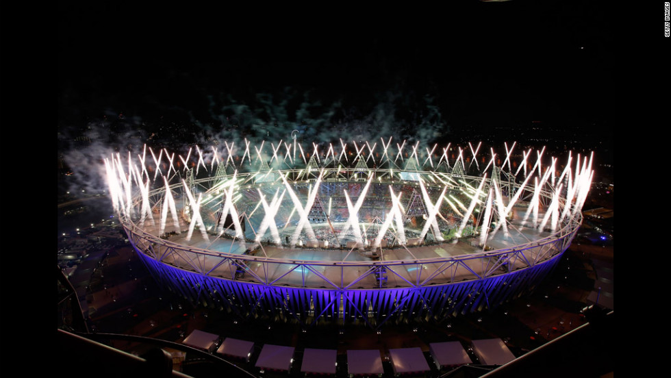Fireworks ignite over the Olympic Stadium.