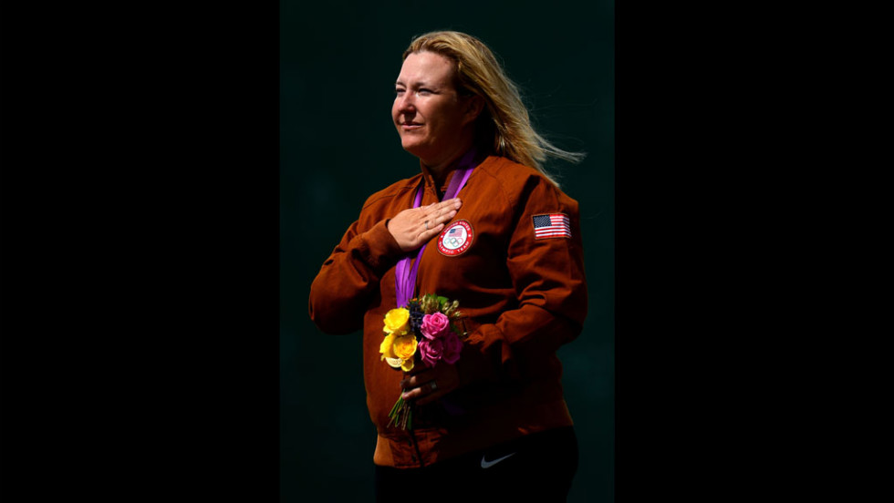 Kim Rhode listens to the U.S. national anthem after winning the gold medal in women&#39;s skeet shooting Sunday.