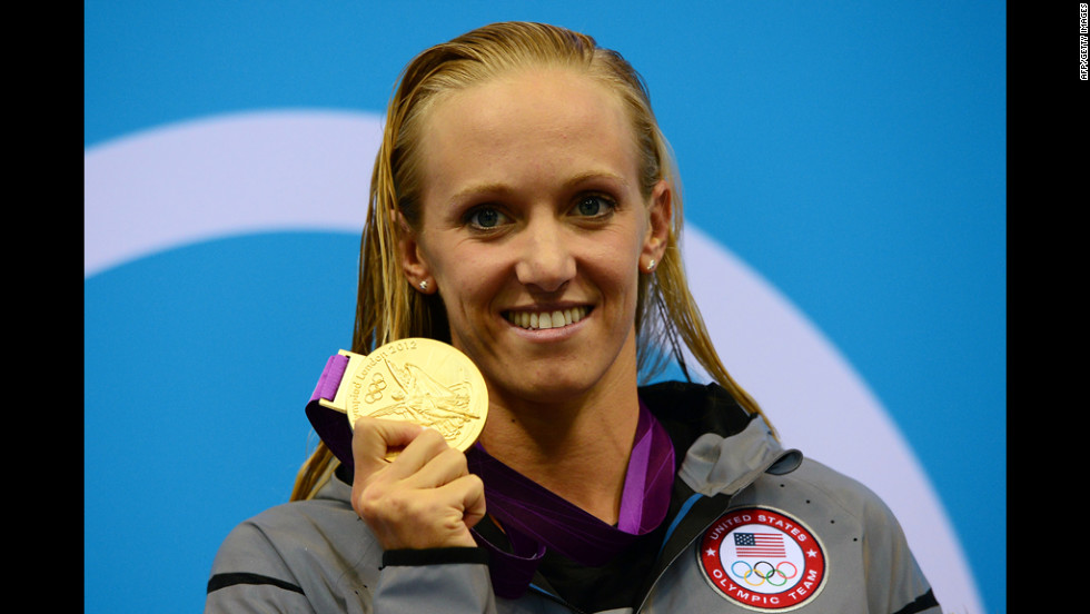 U.S. swimmer Dana Vollmer poses on the podium after winning a gold medal in the women&#39;s 100-meter butterfly final at the London Olympics on Sunday, July 29.