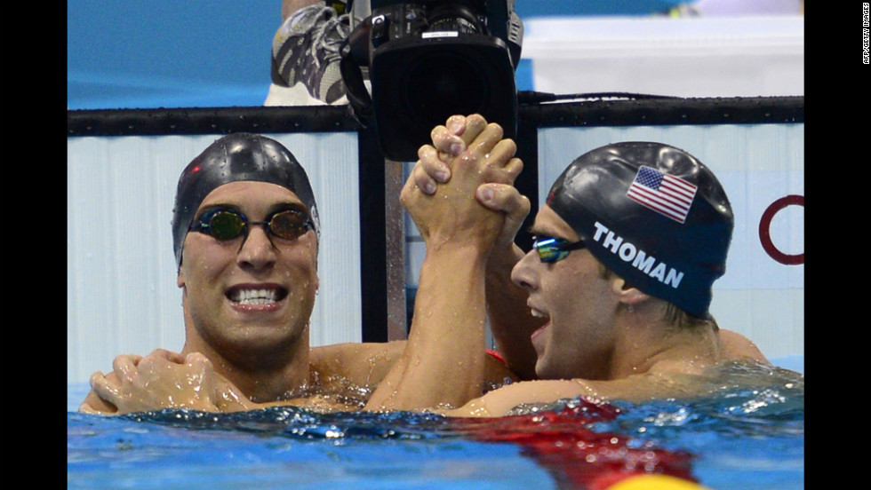 American Matthew Grevers (left) celebrates winning gold with silver medalist and fellow  American Nick Thoman at the finish of the men&#39;s 100-meter backstroke final swimming on Monday.