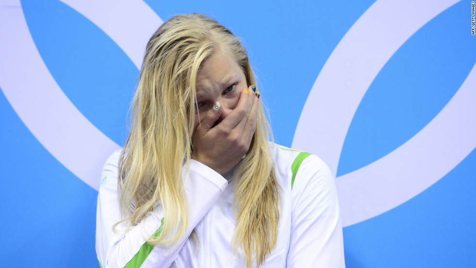 Lithuania&#39;s Ruta Meilutyte stands emotional on the podium to recieve the gold medal after winning the women&#39;s 100m breaststroke swimming event, beating fan favorites Rebecca Soni of the U.S. and Leisel Jones of Australia for the win. 