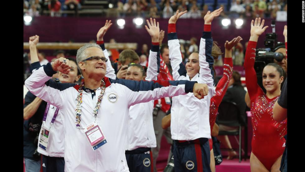 U.S. women&#39;s gymnastics coach John Geddert celebrates with his team after they won the gold in the team competition Tuesday.